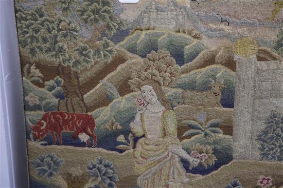 An 18th century needlework panel depicting a shepherdess in a landscape, 26.5 x 22in.